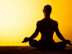 man-practicing-yoga-sunset-light