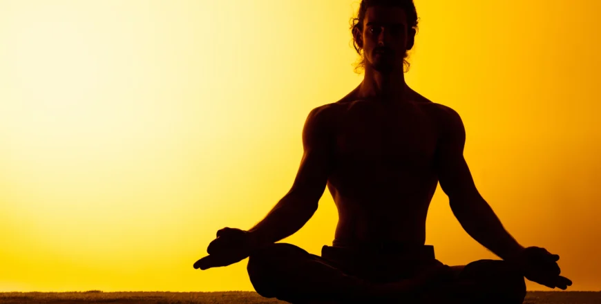 man-practicing-yoga-sunset-light